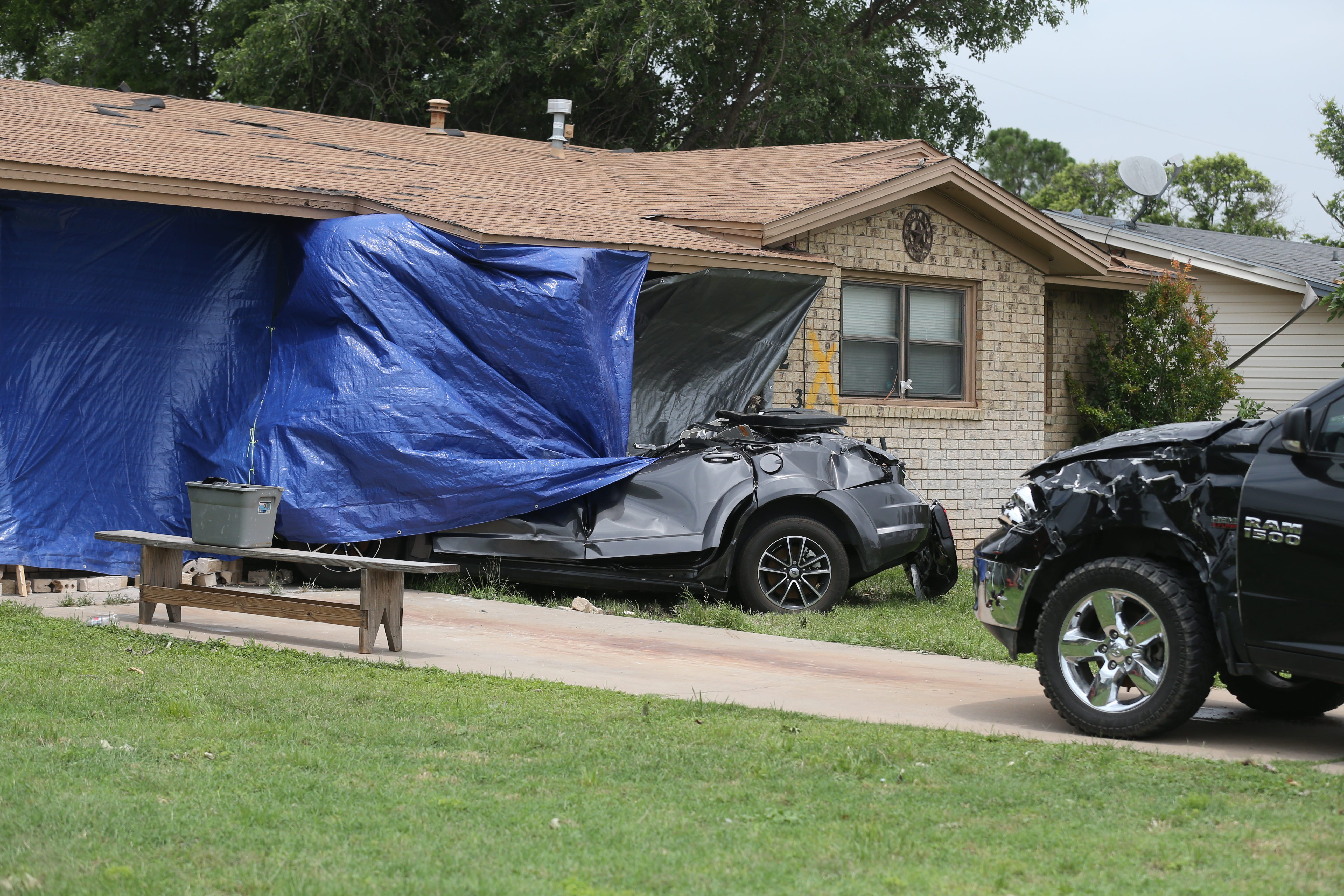 Two vehicles on 24th Street in San Angelo were heavily damaged and one of them slammed into the house during  a storm that hit town early Saturday, May 18, 2019.