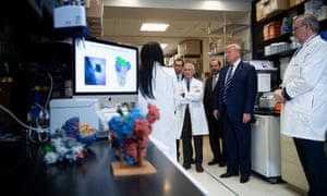 National Institute of Allergy and Infectious Diseases Director Anthony Fauci (C) looks on next to Donald Trump during a tour of the National Institutes of Health’s Vaccine Research Center in Bethesda, Maryland, on Tuesday.