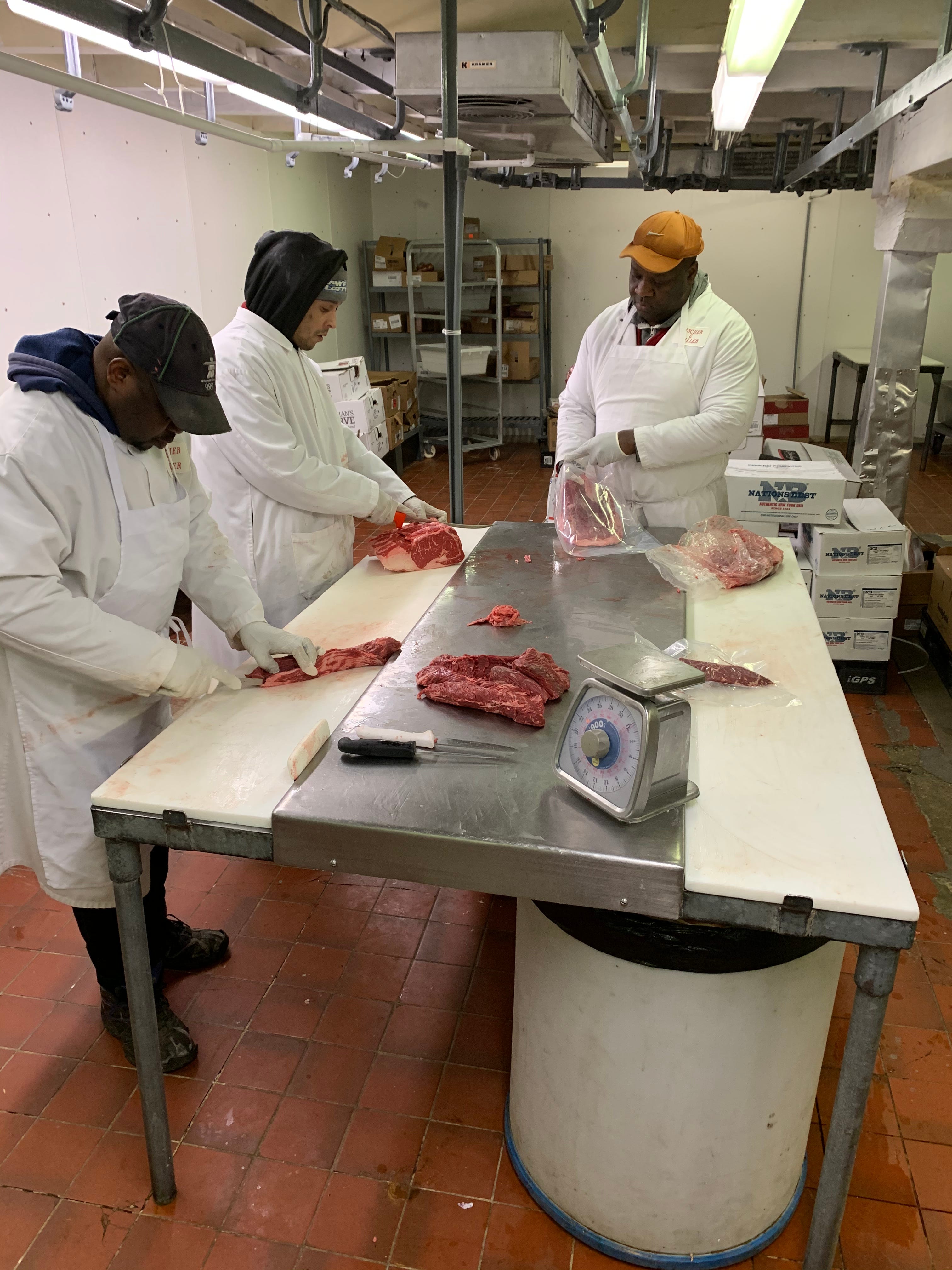 Butchers in the back room at Fischer & Miller Inc. in White Plains.