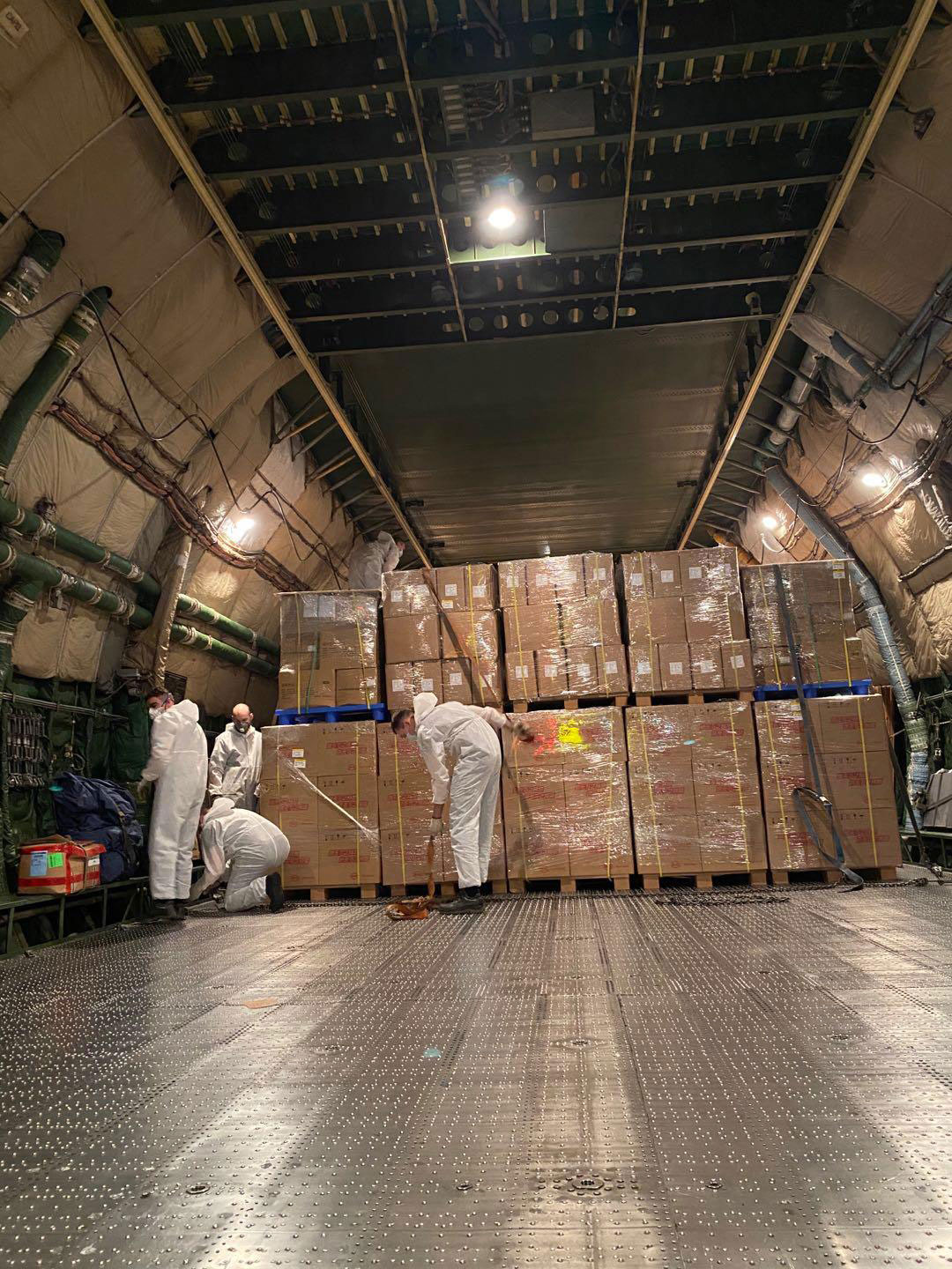 Cargo handlers load Antonov 124 aircraft with medical supplies