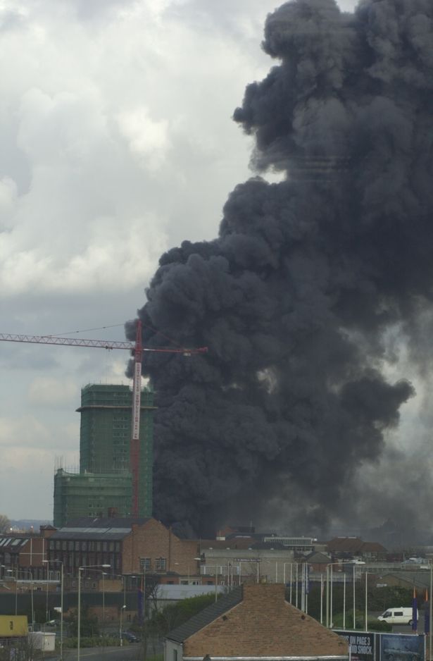 A thick plume of black smoke rises from the burning premises of Mayur Foods in Dysart Way, Leicester, in March 2001