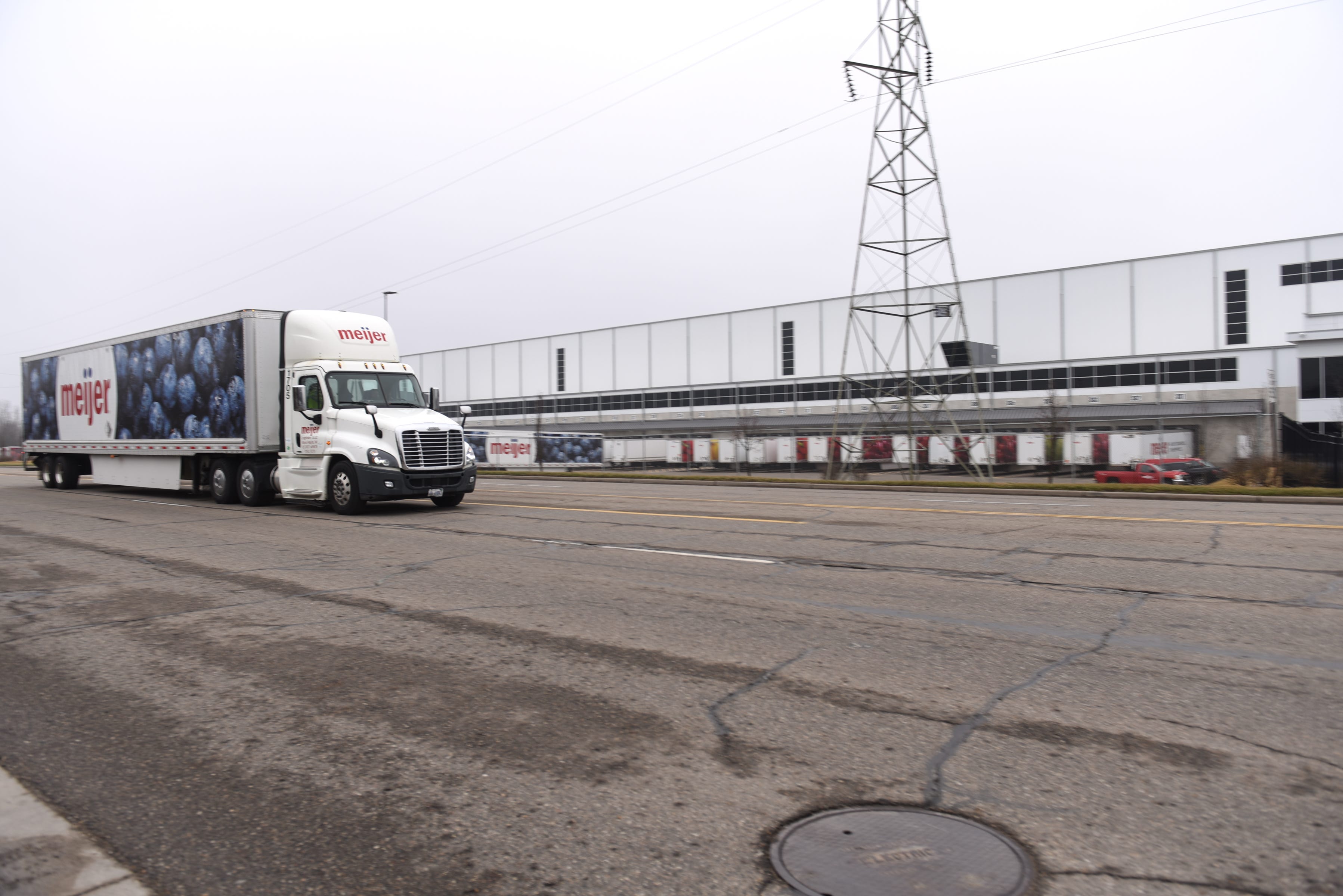A Meijer truck leaves Meijer Distribution Center in Delta Township Thursday March 19, 2020.