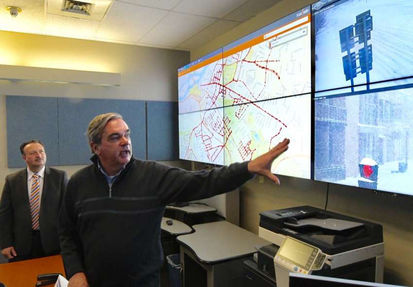 Schenectady Mayor McCarthy and Transfinder CEO Antonio Civitella, background, demonstrate new locating software from Transfinder that Schenectady plow crews used to remove snow from city streets on Tuesday. (Skip Dickstein / Times Union)