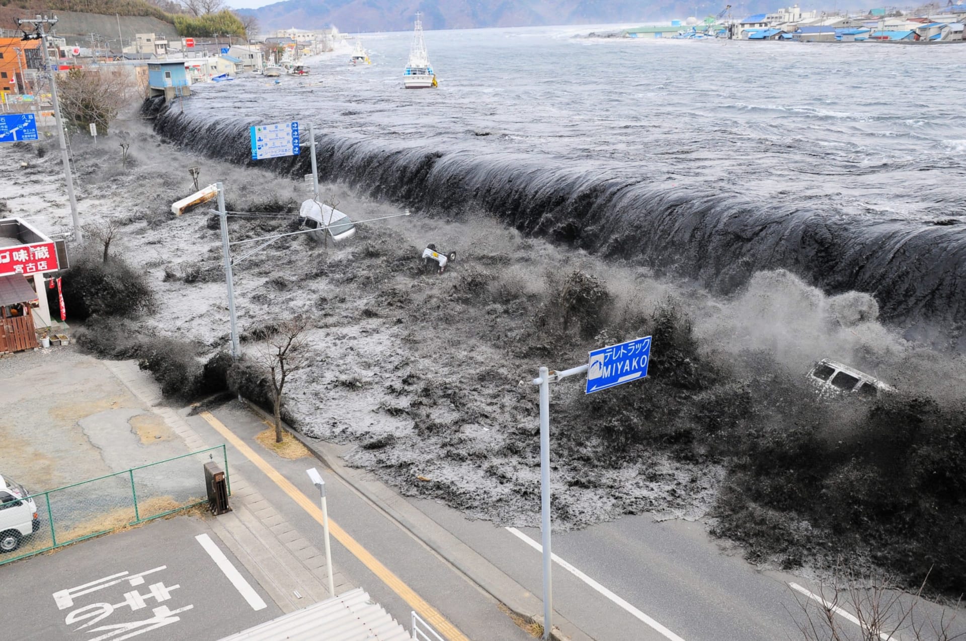 a tsunami floods over the breakwater protecting the coastal city of Miyako at Heigawa estuary area after northeastern Japan was hit by a powerful earthquake.