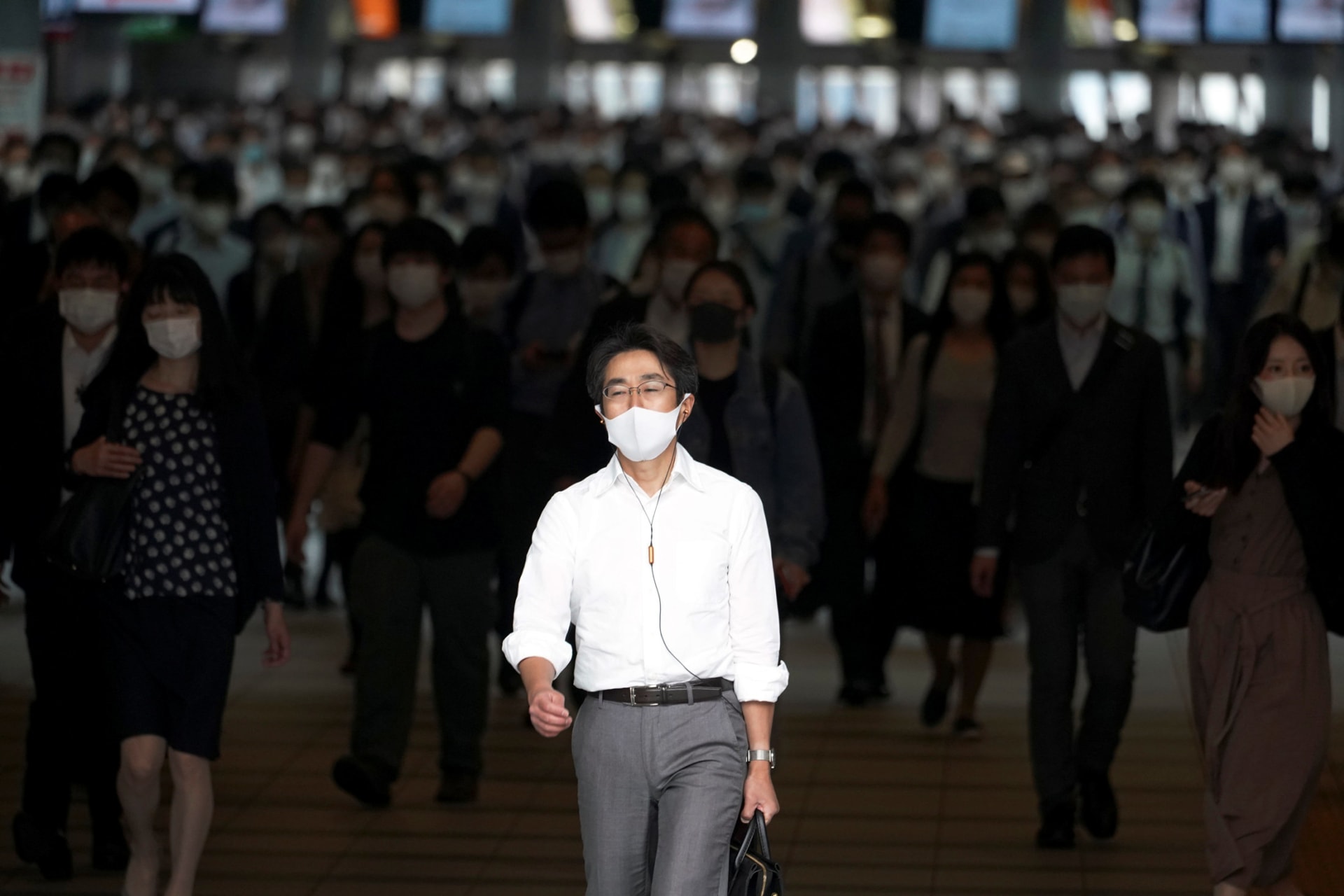 A station passageway is crowded with commuters wearing face mask during a rush hour May 26, 2020, in Tokyo. 
