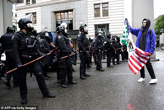 Thousands of people gathered in Seattle in the rain to protest the killing of George Floyd