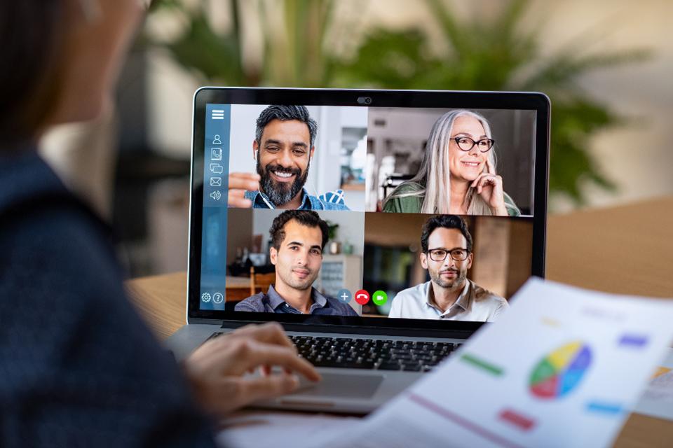 Business woman meeting with coworkers virtually.