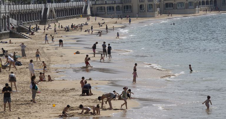 Beachgoers at La Concha beach in San Sebastián.