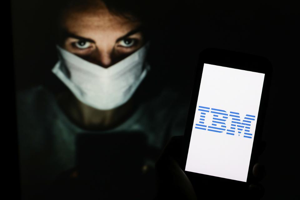 In this photo illustration an IBM company logo seen...
