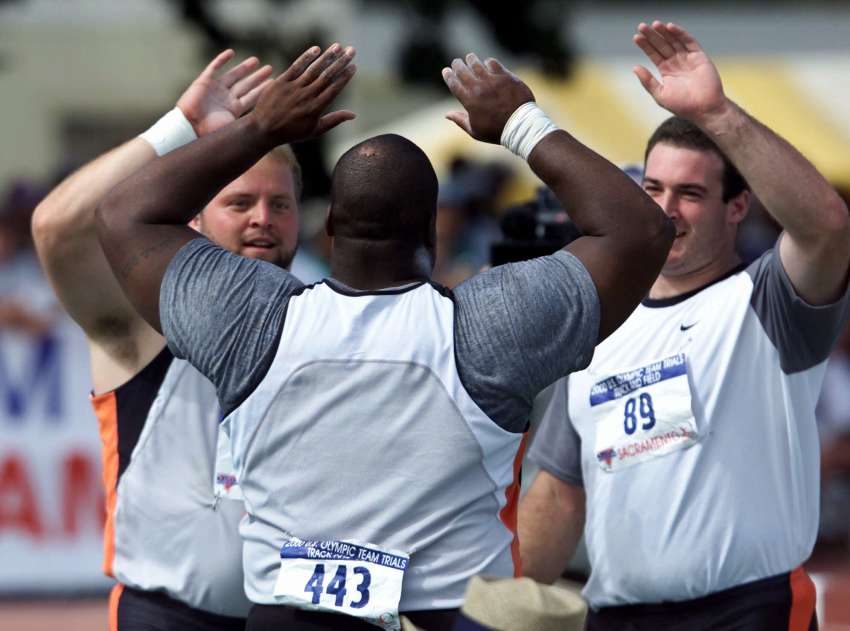 Shot putters Adam Nelson, left, C.J. Hunter and Andy Bloom, right, congratulate each other on their finishes at the U.S. Olympic Track and Field Trials in Sacramento, Calif., Saturday, July 15, 2000.