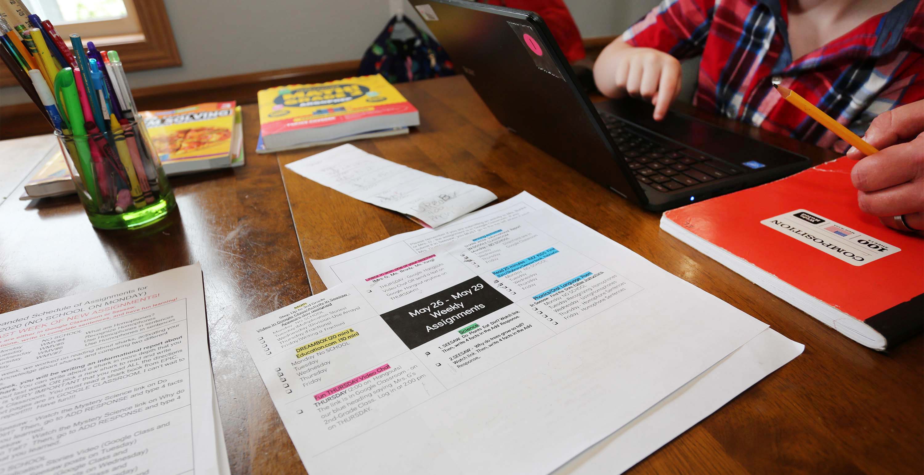 A copy of the lesson plans for Eli Bartell lay on the kitchen table last week at the family's Sheboygan home. In the backgrounds are some workbooks Andy Bartell says he is planning to work with his son Eli, 8, over the summer months.