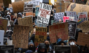 Protesters hold placards at a Black Lives Matter demonstration in Parliament Square in central London on Saturday.