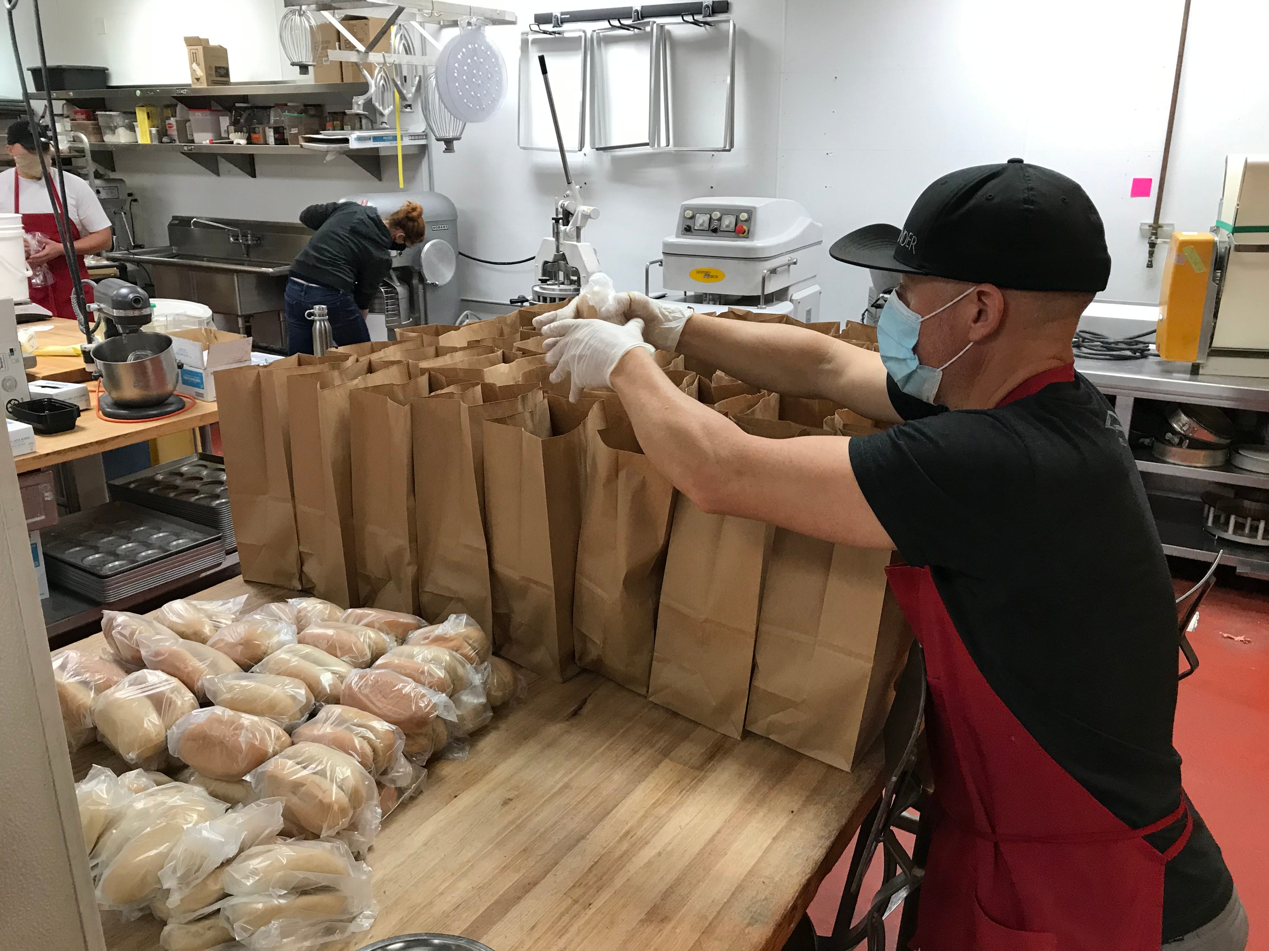 Meals are packed at Liberty Food & Wine Exchange in downtown Reno for Delivering with Dignity meals that are provided gratis to locals most at risk for coronavirus infection.