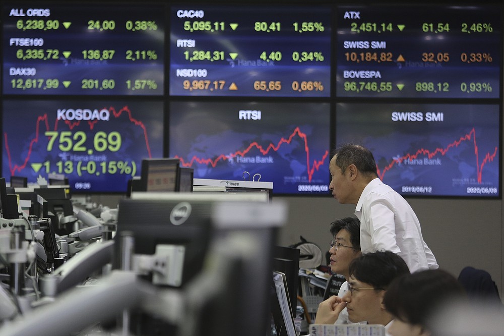 Currency traders watch monitors at the foreign exchange dealing room of the KEB Hana Bank headquarters in Seoul, South Korea, Wednesday, June 10, 2020. Shares were trading slightly higher in Asia on Wednesday after a weekslong rally on Wall Street hit the brakes. (AP Photo/Ahn Young-joon)