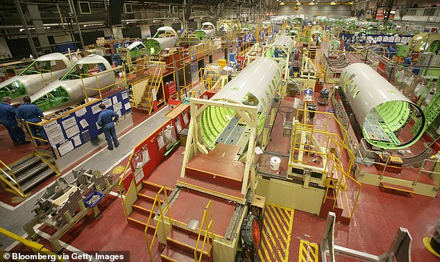 The manufacturer said the 'extraordinary industry interruptions and challenges' caused by the coronavirus crisis has led it to take the action. Pictured: Workers inside the Bombardier plant in Belfast