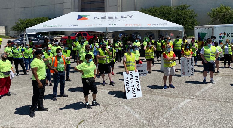 Volunteers stand ready to pass out food and supplies - June 13, 2020