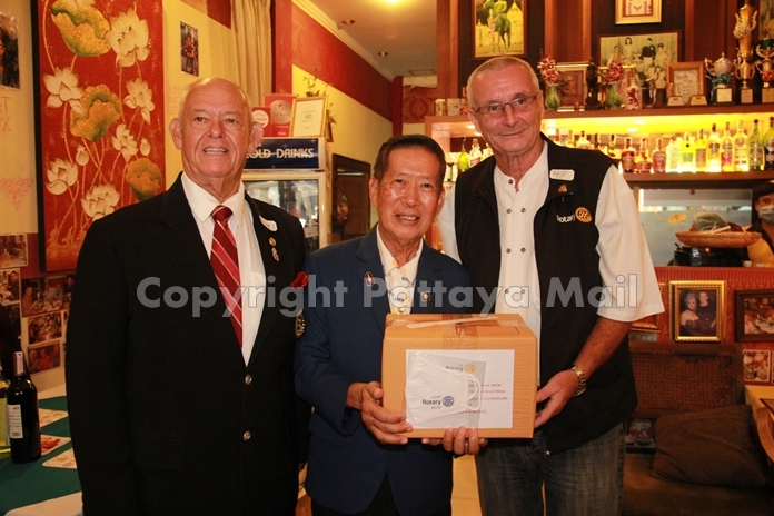 Pres. Dieter Barth of the Rotary Club Phoenix Pattaya gets his box of face masks from DG Maruai Jintabunditwong.