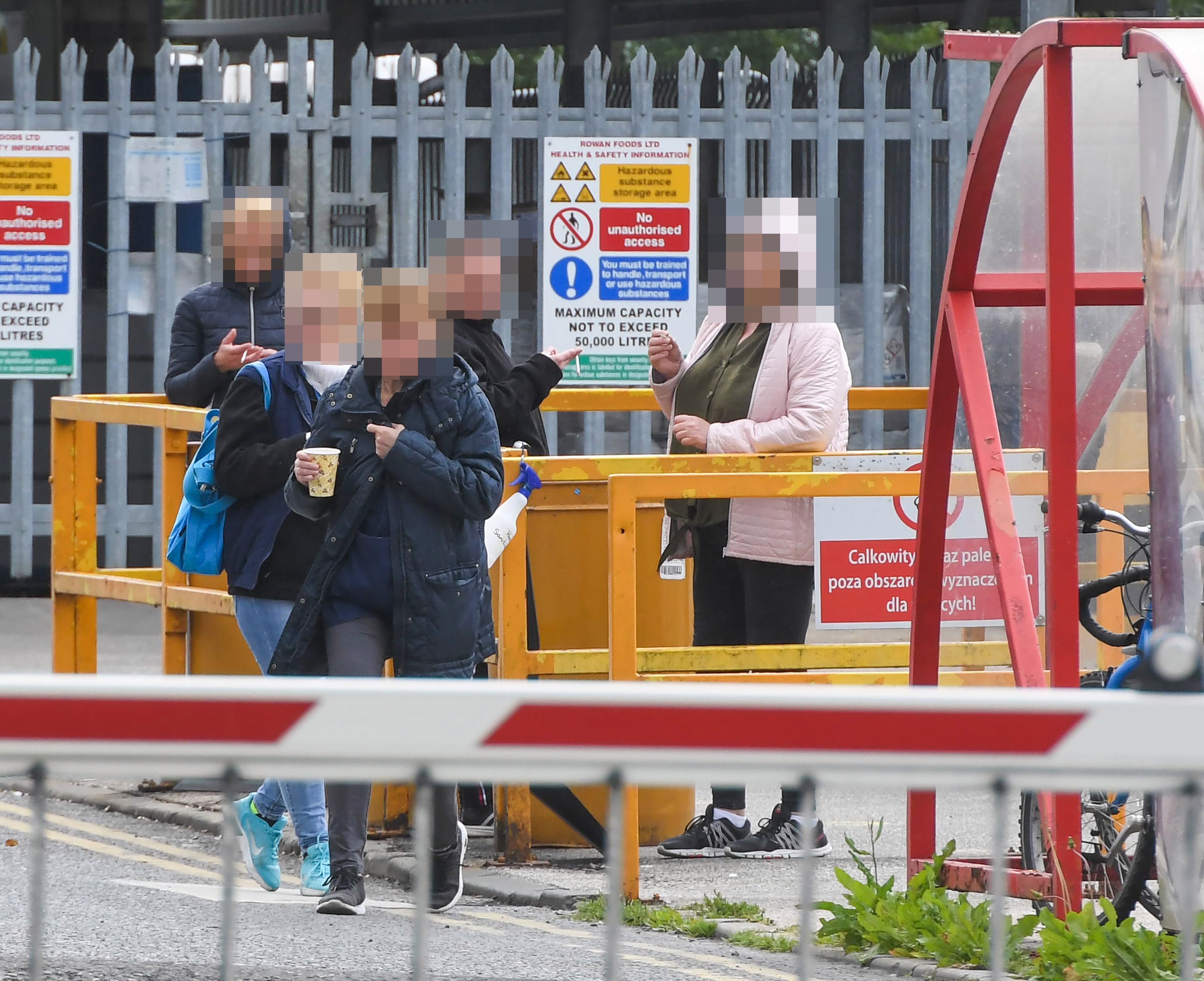 Staff huddled close together on breaks outside the factory