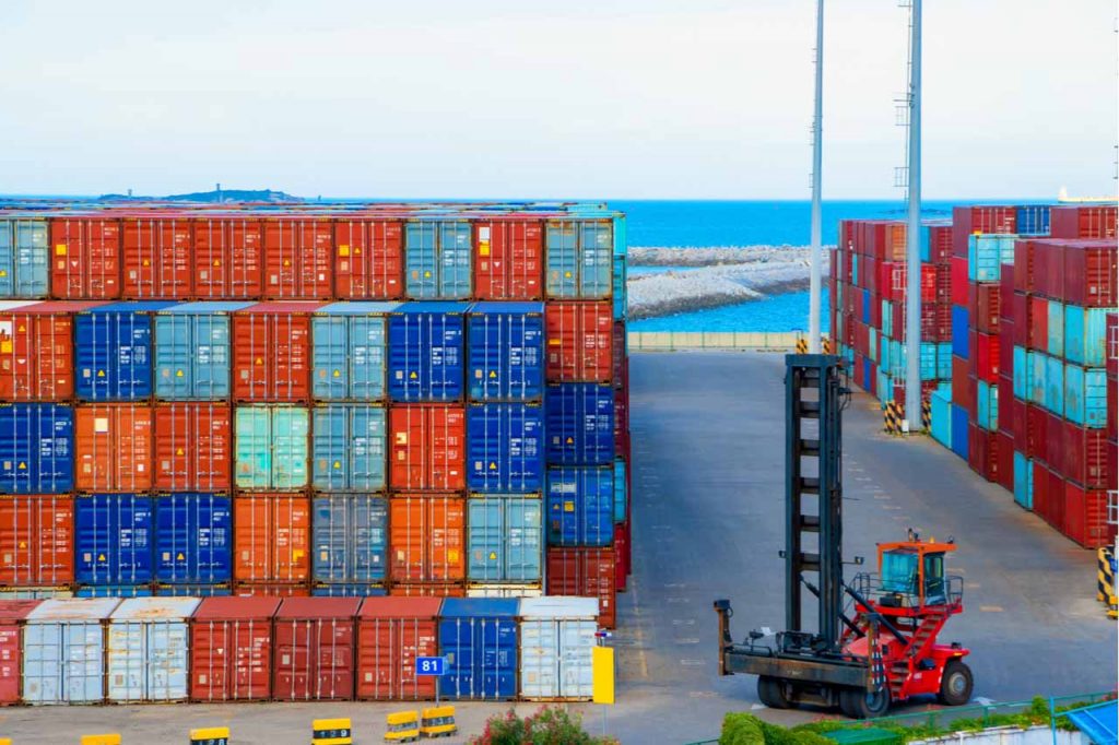 Cargo containers stacked at a shipping terminal.