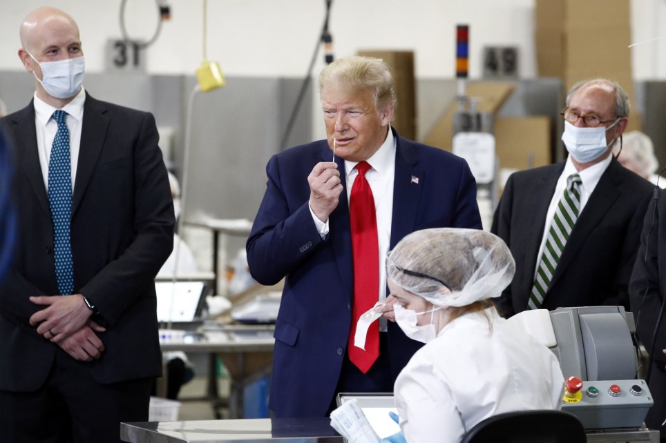 Photo of Trump holding swab up to his nose