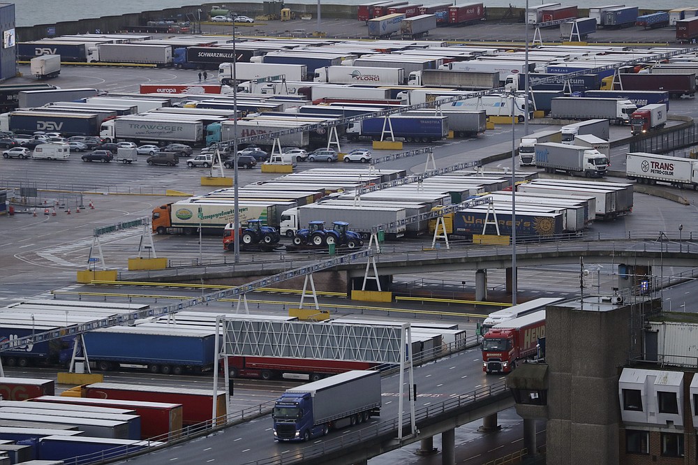 FILE - In this file photo dated Saturday, Feb. 1, 2020, lorries leave after disembarking a ferry as others wait to board on the morning after Brexit took place at the Port of Dover in Dover, England.   The British government is expected to water down plans for full border checks on goods coming from the European Union amid economic devastation caused by the coronavirus pandemic, according to new reports Friday June 12, 2020, Michael Gove, the minister in charge of Brexit preparations, will announce a more “pragmatic and flexible” approach to imports. (AP Photo/Matt Dunham, FILE)