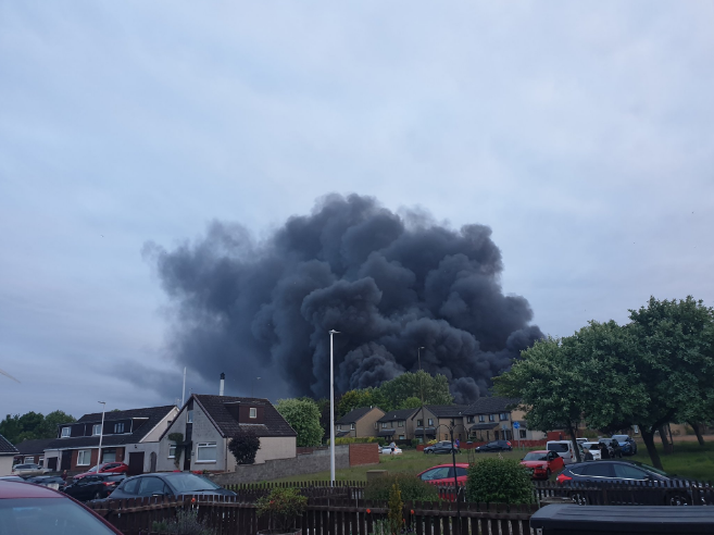  The thick black clouds of smoke billow across the sky