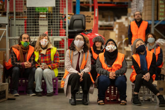 CERES workers listen as Gelareh Pour performs from a mezzanine walkway.