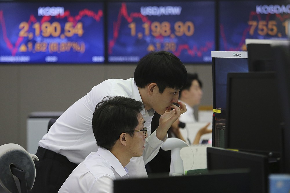Currency traders watch monitors at the foreign exchange dealing room of the KEB Hana Bank headquarters in Seoul, South Korea, Wednesday, June 10, 2020. Shares were trading slightly higher in Asia on Wednesday after a weekslong rally on Wall Street hit the brakes. (AP Photo/Ahn Young-joon)