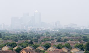 Urban smog seen shrouding Canary Wharf from a residential estate in London.