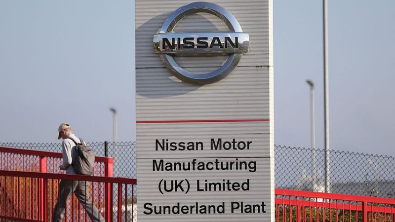 Workers leave the Nissan car plant after finishing their shift in Sunderland.