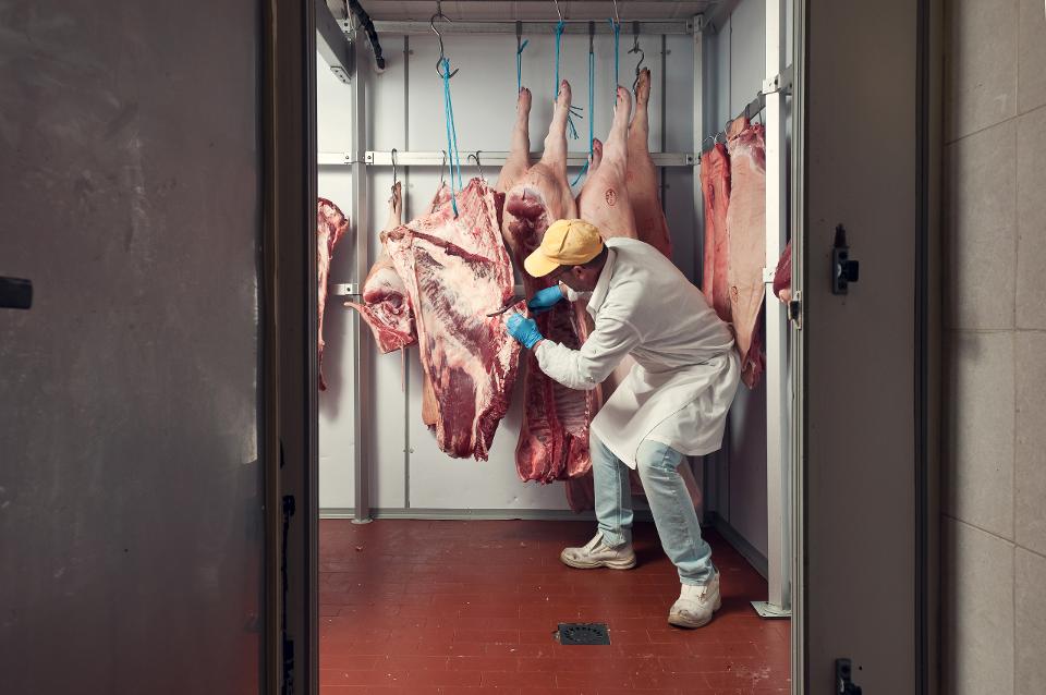 A butcher cuts meat.