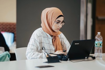 A student works with her laptop