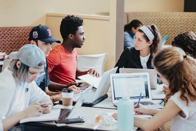 A group of students work on their laptops