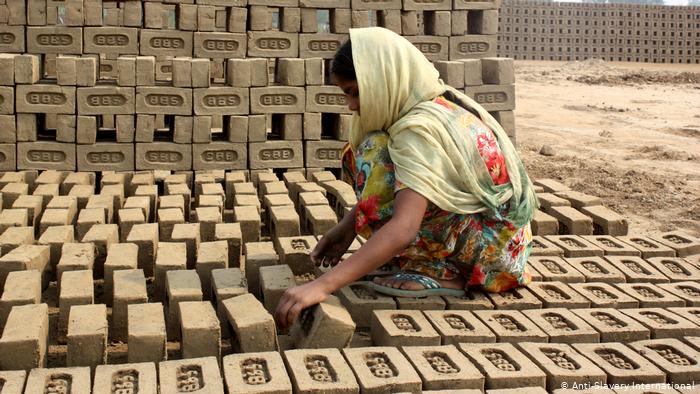 Millions held in debt bondage. Here a worker in a brick factory