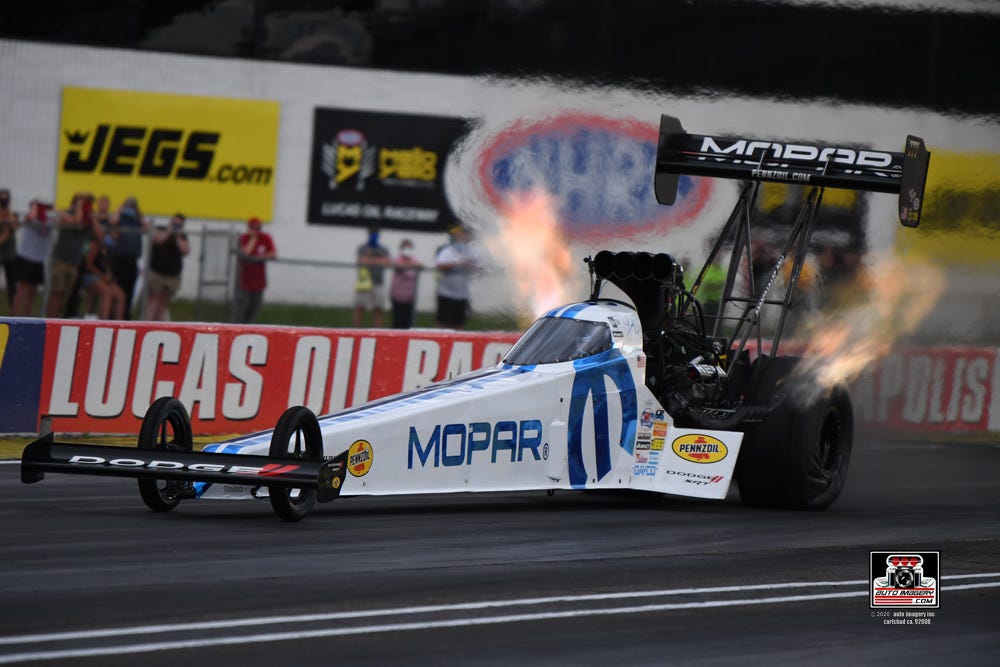 Top Fuel driver Leah Pruett's car bursts down the track at Lucas Oil Raceway.