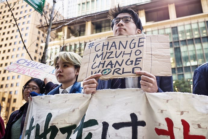 Climate activists protest outside Mizuho Financial in Tokyo. Some 35% of shareholders supported a proposal for the banking group to disclose a Paris agreement plan