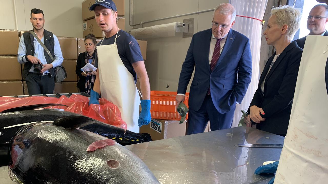 VISIT: Prime Minister Scott Morrison inspecting some of the catch at Walker Seafoods Australia, with owners Pavo and Heidi Walker.