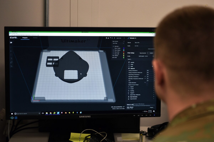 U.S. Air Force Tech. Sgt. Tracy Gibbs, 312th Training Squadron Special Instruments Training course graduate, prepares a 3D printed N95 face mask to be printed through modeling software.