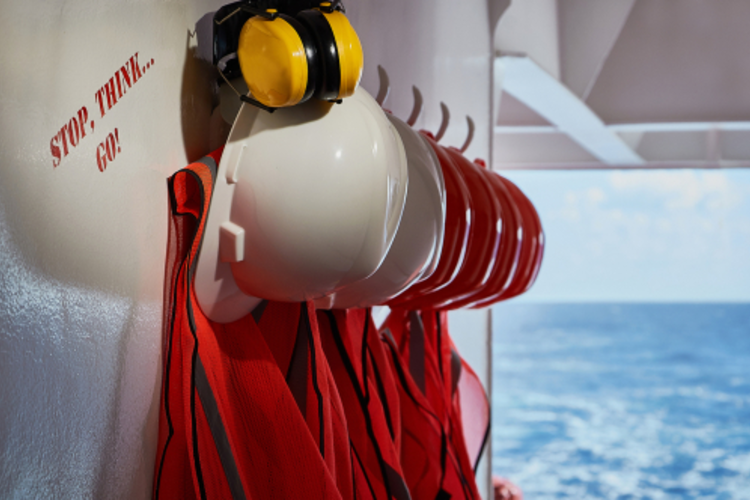 Safety sign next to gear for shipping workers.