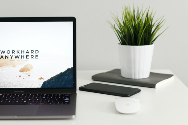 Laptop with screensaver saying: "Work hard anywhere"