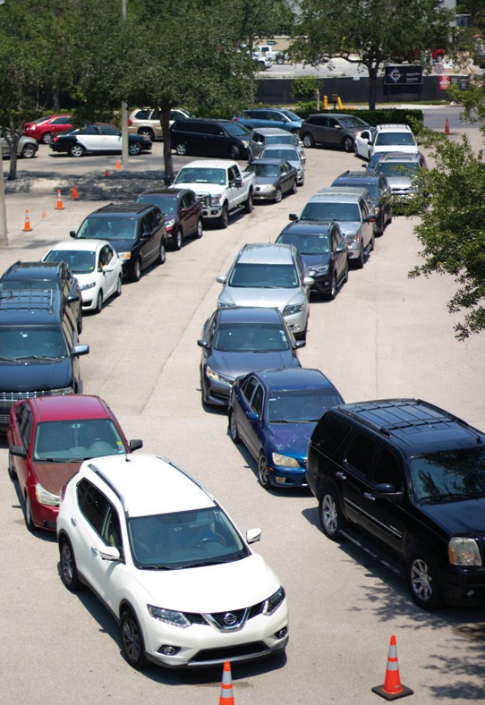 Cars line up for a recent St. Matthew’s House food distribution, which previously served 30 to 70 families weekly. Now, it is serving between 1,500 and 2,000 families weekly.” COURTESY PHOTO