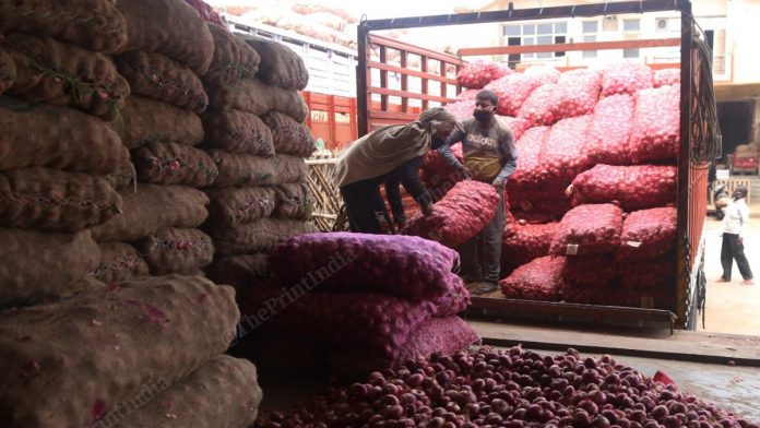 Labourers unloading sacks of onion in Azadpur mandi in Delhi | Photo: Manisha Mondal | ThePrint