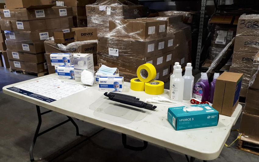 Some personal protective equipment supplies are stacked on a table in one of Elections N.B.'s warehouses in Fredericton.