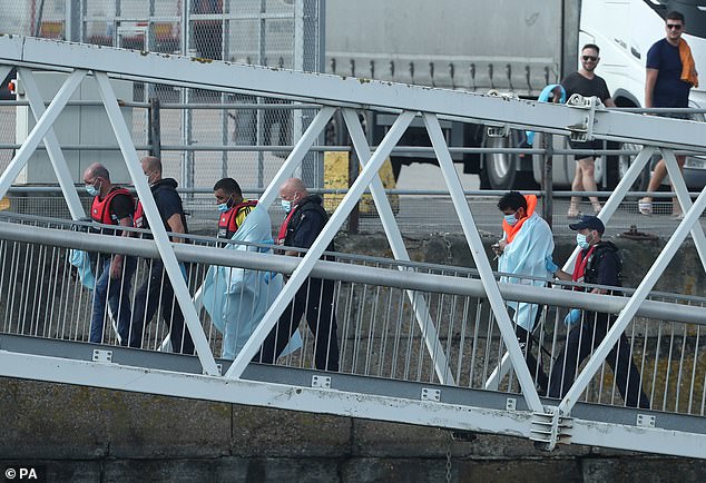 Another 151 migrants made the dangerous crossing on Saturday, bringing the total the number to 532 since Thursday. Pictured: Migrants are led to shore