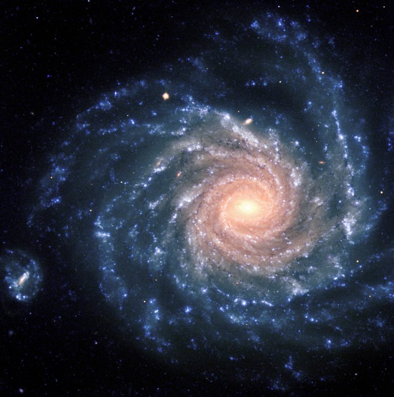 Bluish spiral with many clumpy arms and bright yellow-pink center.