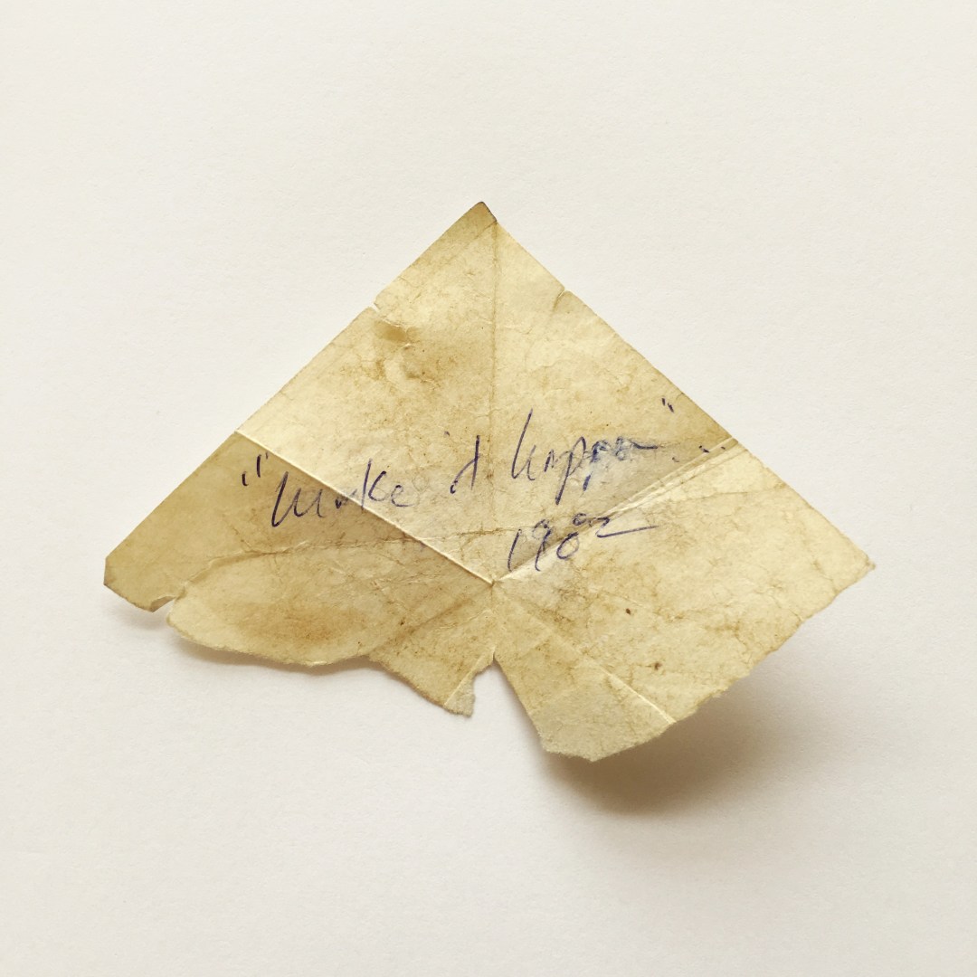 A folded piece of paper with the words "Make it happen" is dated 1982