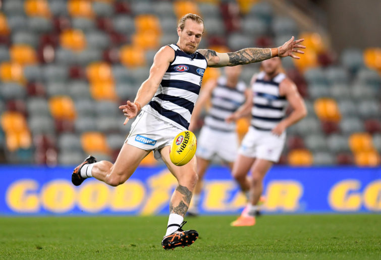 Tom Stewart of the Cats kicks the ball