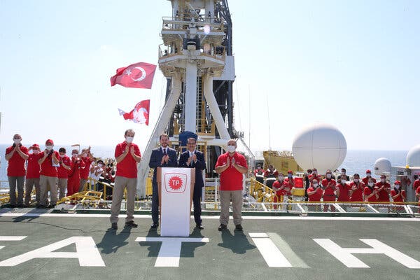 Turkey’s finance minister, Berat Albayrak, and energy minister, Fatih Donmez, applaud after announcing the discovery of the gas field on the deck of drilling vessel on the Black Sea Friday.