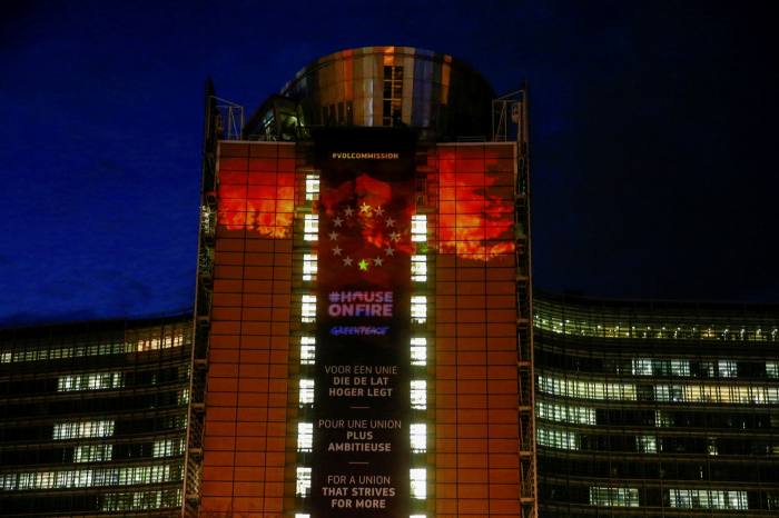 Greenpeace activists project images on the European Commission HQ in Brussels. Insurers and pension funds are taking a bigger interest in carbon as a potential hedge against the effects of climate change