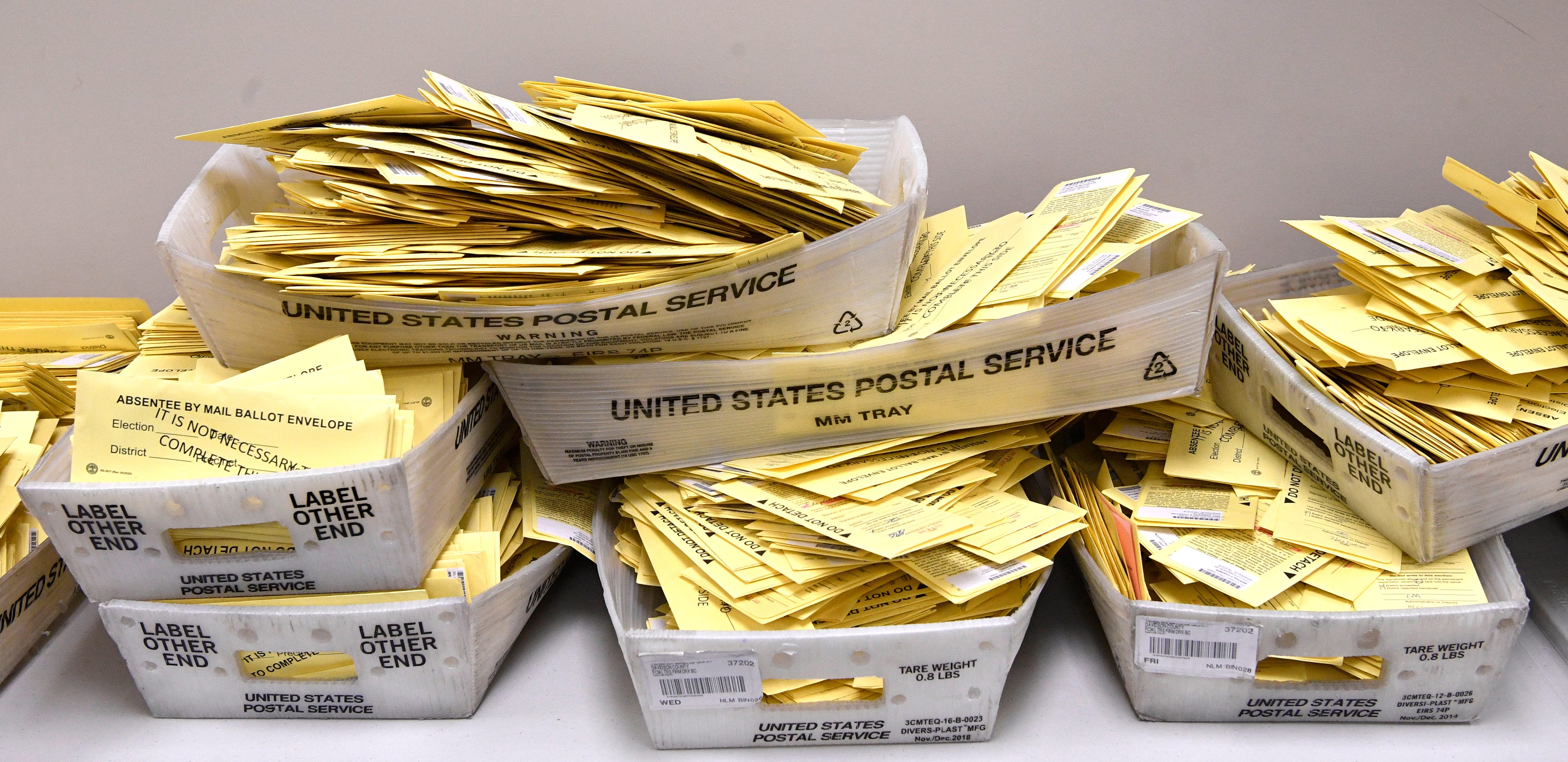 Mail-in ballots are piled up, waiting to be counted at the election commission so they can then be scanned in Nashville, Tenn. Thursday, Aug. 6, 2020
